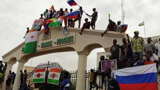 Coup supporters in Niger wave Russian flags. 