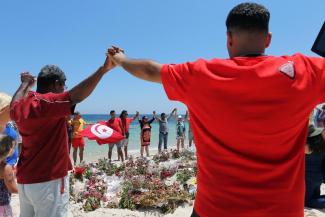 A moment of collective grief on the beach at Sousse.