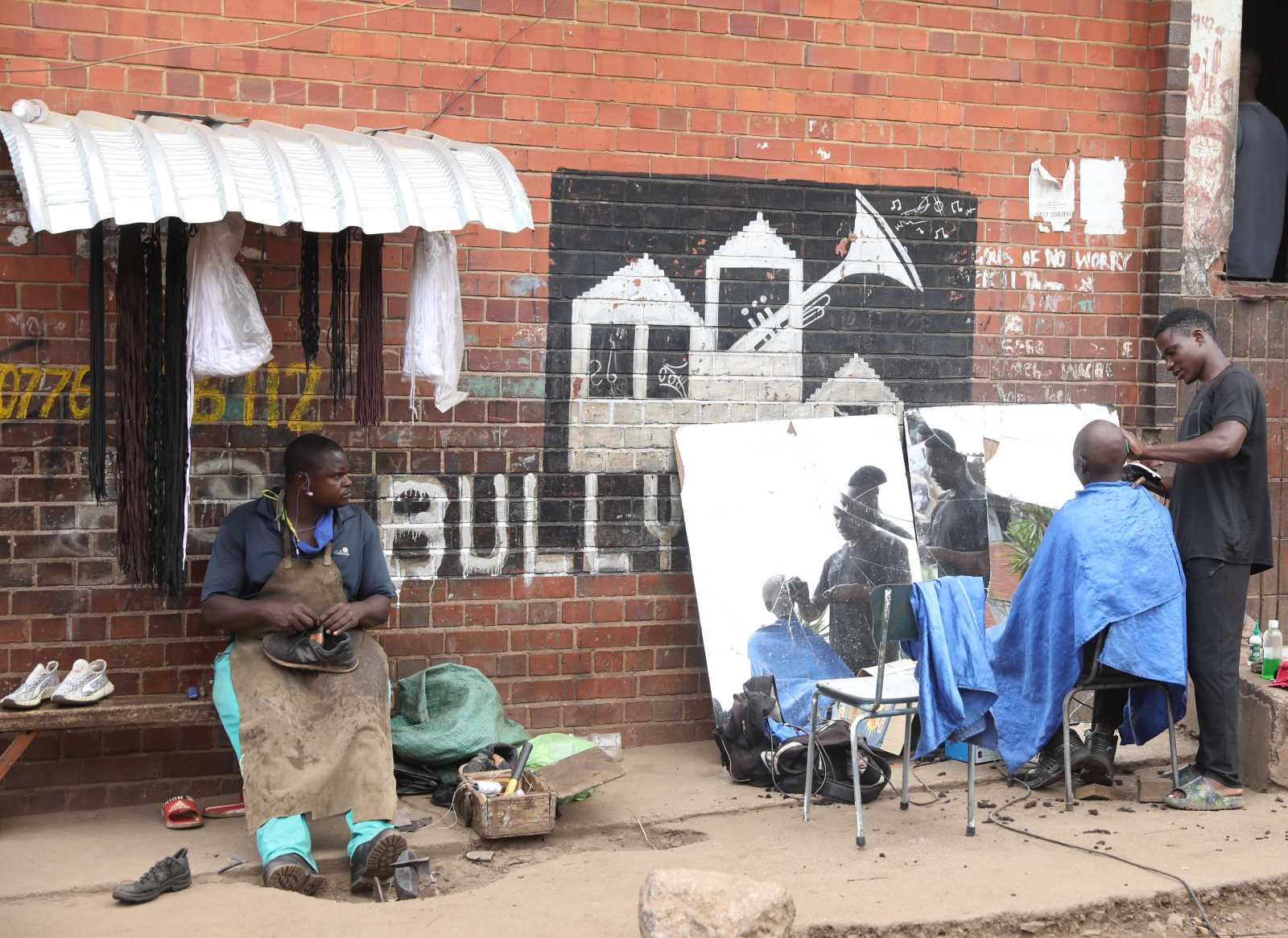Street-side barbershop in Zimbabwe.