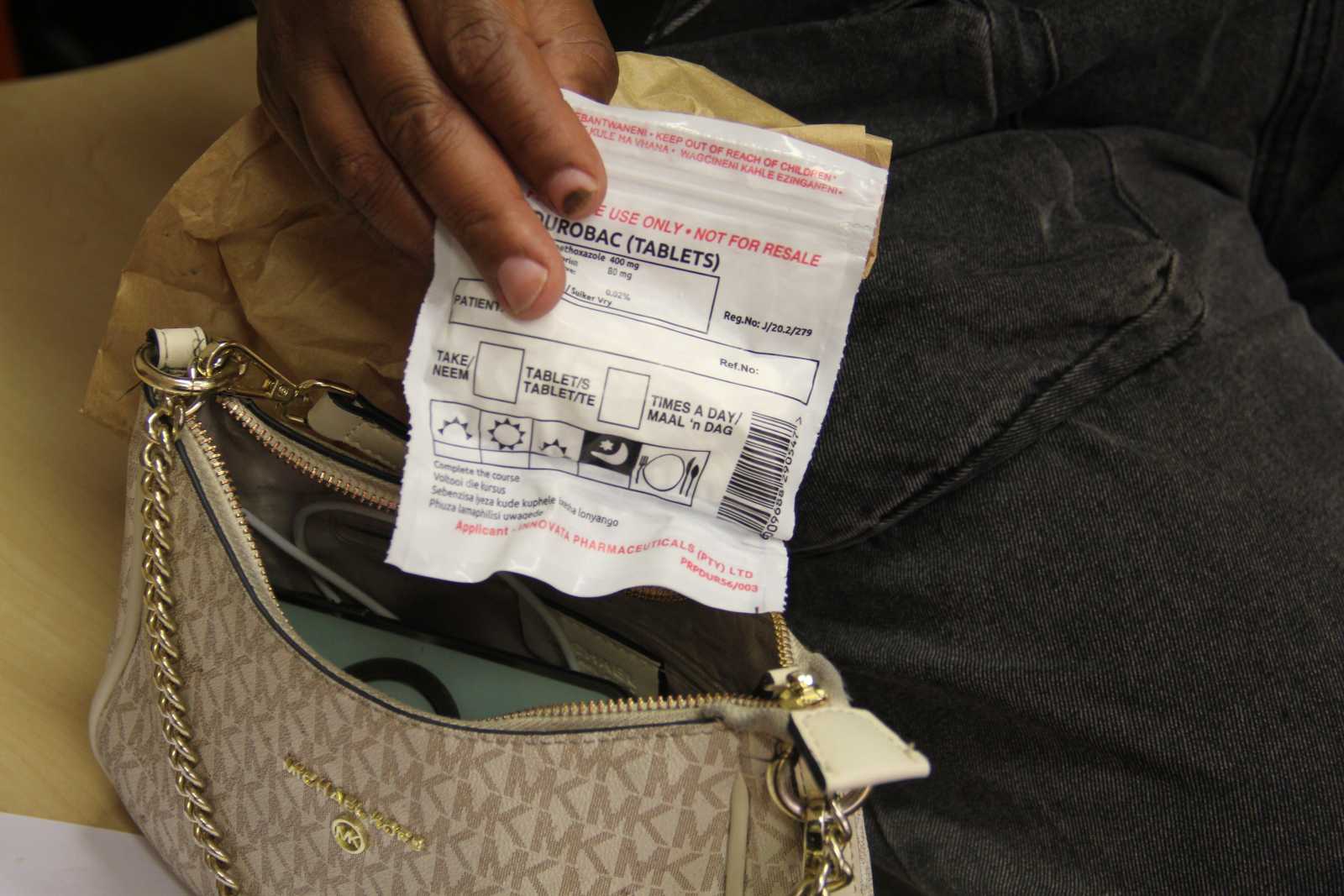An HIV-positive sex worker in Johannesburg holds antiretroviral drugs provided to her by the government. However, many sex workers now have to rely on the black market to obtain these drugs.