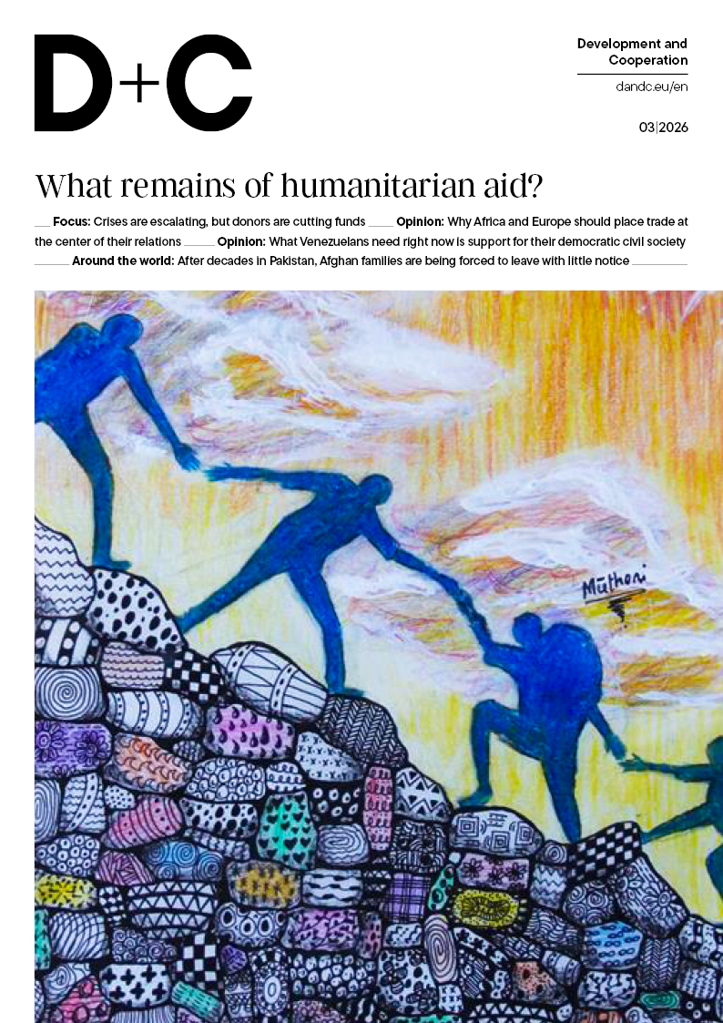 Cover of D+C magazine (03/2026) titled “What remains of humanitarian aid?” featuring an illustration of blue silhouettes reaching hands to each other across a colorful, patterned mound.