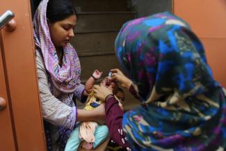 A health worker administers polio drops during a vaccination campaign in Karachi, Pakistan.