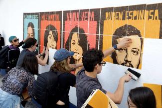 At the Public Prosecutor General’s Office in Mexico City, murder victims’ families demanding justice put up portrait posters of those killed.