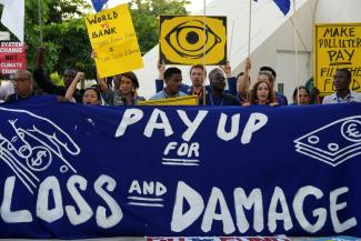 Activists participate in a demonstration for the loss and damage fund at COP28 in Dubai.