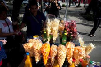 A street vendor sells fried snacks and soft drinks in Mexico City.