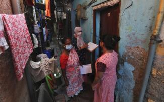 Overcrowded Mumbai slum: health workers screening for TB during the Covid-19 pandemic. 