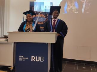 Ronald Ssegujja Ssekandi Our author and a friend at their graduation ceremony at Ruhr-Universität Bochum.