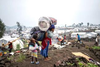 Fleeing again and again: People displaced by fighting leave their camp following an order from M23 rebels in Goma.