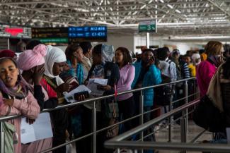 Travelers wait with their documents at the airport in Addis Ababa. In many places, fast-track options make it easier to obtain visas, at least for the wealthy.