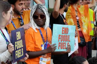 dpa / ASSOCIATED PRESS / Peter Dejong What motivates people to take climate action? Namibia-based activist Ina-Maria Shikongo at a demonstration during the COP28 UN Climate Summit in Dubai in 2023.