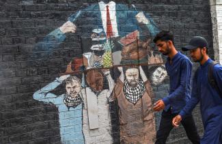 A mural on a wall at Punjab University in Lahore depicts the burden placed on the poor to sustain the lifestyle of the elite.