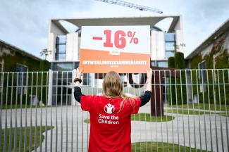 Protest against funding cuts in German development aid in front of the Federal Chancellery in July 2026.