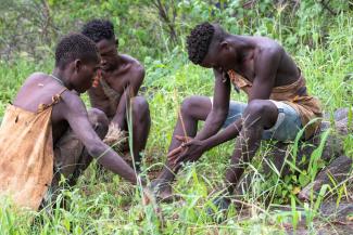 Hadzabe hunters light a fire near Lake Eyasi in northern Tanzania.