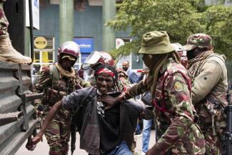 A young man is arrested during the protests in Kenya in 2024.