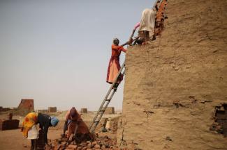 Personnel from the International Criminal Court are not allowed to collect evidence in Sudan. Refugee women work in a brickyard in the conflict region of Darfur.