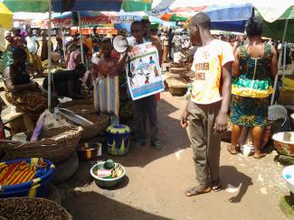 A member of NMJD informs the people about the Ebola epidemic.