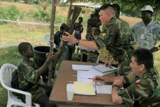 Disarming a former child soldier in Liberia 2003.