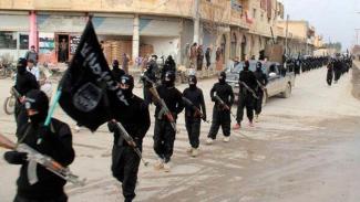 ISIS fighters march in Raqqa, Syria in 2014.