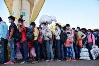 Limited scope for social distancing: migrant workers hoping to catch a bus in Delhi on 29 March