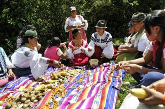 Indigenous community in Ecuador sharing a meal.