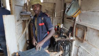 A former child soldier is being taught to work as a cobbler in a Rebound Centre in the Democratic Republic of the Congo.