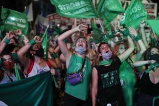 Women’s-rights activists celebrating in Buenos Aires after legislators passed the new law on 30 December 2020.