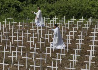 Priests blessing mass grave in Tacloban on the 1st anniversary of Super Typhoon Haiyan in November last year.