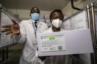 Precious asset: technicians in Nairobi with a carton of AstraZeneca Covid-19 vaccine manufactured by the Serum Institute of India.