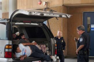 Police officers with arrested illegal immigrants near San Diego, California.