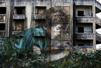 Graffiti on a bullet riddled building on the former frontline of the Lebanese civil war in downtown Beirut (photo taken in 2018).