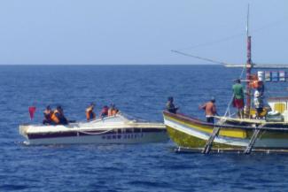 Chinese coast guard confronting Filipino fishermen near Scarborough Shoal,  which is historically claimed by both countries.
