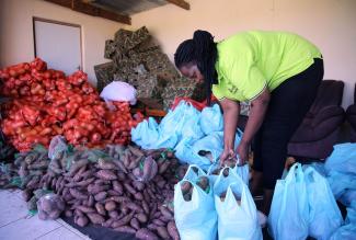 In a Durban township in KwaZulu-Natal, South Africa, a woman collects a food parcel provided by a group fighting against hidden hunger.