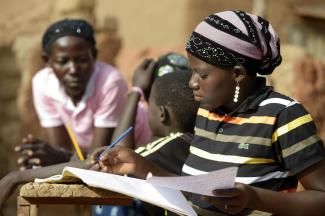 Education matters: a high-school student doing homework in rural Burkina Faso.