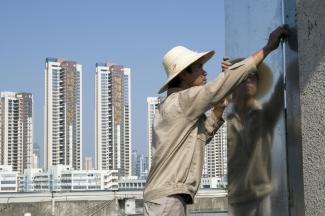 Theme park in Shenzhen. , Construction worker with a metal sheet in Guangzhou.