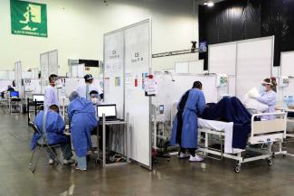 Temporary Covid-19 hospital in an exposition centre in Mexico City: around the world, health care needs additional resources.