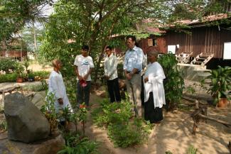 Development worker talking to project partners in Cambodia 2005.